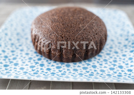 A side view of a fluffy chocolate steamed bun. A side view of a fluffy chocolate steamed bun. 142133308