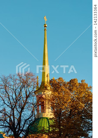 Spire of the Engineering castle across the Moika River with a beautiful embankment on a sunny autumn evening, Russia, St.Petersburg Spire of the Engineering castle across the Moika River with a beautiful embankment on a sunny autumn evening, Russia, St.Petersburg 142133364