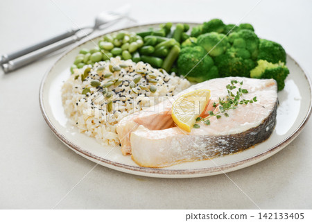 Balanced healthy meal with baked salmon with brown rice and vegetables Balanced healthy meal with baked salmon with brown rice and vegetables 142133405