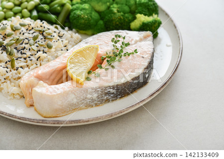 Balanced healthy meal with baked salmon with brown rice and vegetables Balanced healthy meal with baked salmon with brown rice and vegetables 142133409