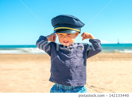 Different emotions of children enjoying a day at the beach while interacting with the sea and playing in the sun Different emotions of children enjoying a day at the beach while interacting with the sea and playing in the sun 142133440