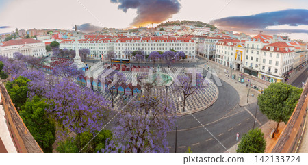 Rossio Square with Jacaranda Trees at Sunrise in Lisbon, Portugal Rossio Square with Jacaranda Trees at Sunrise in Lisbon, Portugal 142133724