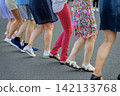 Women Dancing Horo in Row on Street. Dancing in row, traditional horo dance outdoors in Bulgaria. Cultural group movement scene focused on legs, rhythm, community, folk dance tradition 142133768