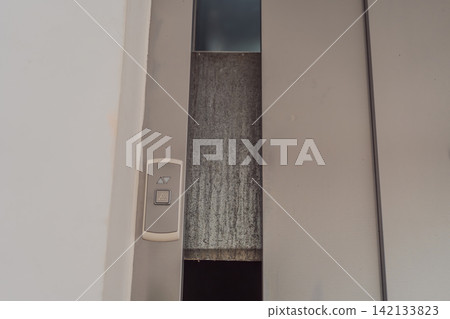 Elevator stuck between floors with doors open, showing lift malfunction, building safety issue, urban infrastructure problem and emergency risk concept Elevator stuck between floors with doors open, showing lift malfunction, building safety issue, urban infrastructure problem and emergency risk concept 142133823