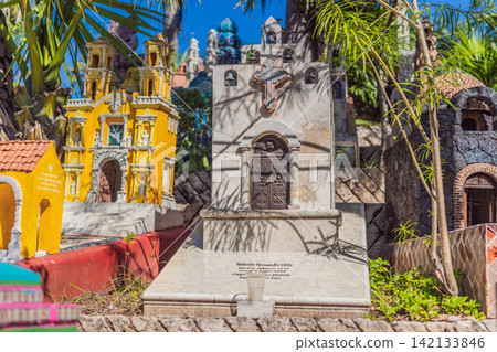 Decorative small buildings, crosses and bright details show Mexican folk art, cultural heritage, Day of the Dead style and travel background concept Decorative small buildings, crosses and bright details show Mexican folk art, cultural heritage, Day of the Dead style and travel background concept 142133846