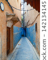 Narrow alley with blue painted passage Narrow alley with blue painted passage 142134145