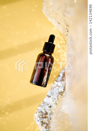 Skincare cosmetic dropper bottle with serum on yellow background Skincare cosmetic dropper bottle with serum on yellow background 142134696