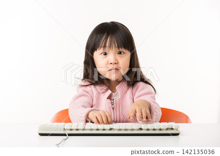 Confused Asian Little Girl Struggling with Computer Keyboard 142135036