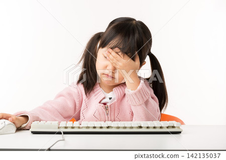 Tired Asian Little Girl Feeling Exhausted While Using Computer Tired Asian Little Girl Feeling Exhausted While Using Computer 142135037