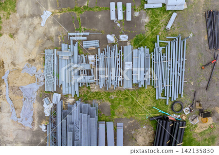 Different types of construction materials are spread out on ground at worksite Different types of construction materials are spread out on ground at worksite 142135830
