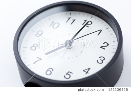 A clock showing 7 o'clock A clock showing 7 o'clock 142136526