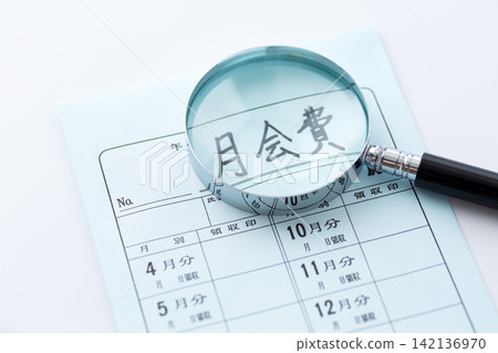 Monthly fee and magnifying glass Monthly fee and magnifying glass 142136970