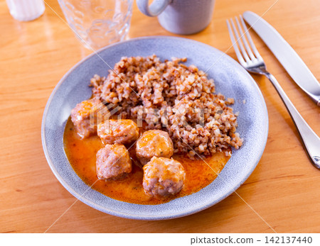 Meat balls with buckwheat on a plate top view 142137440
