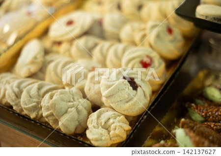 cookies with toppings on display in the store 142137627