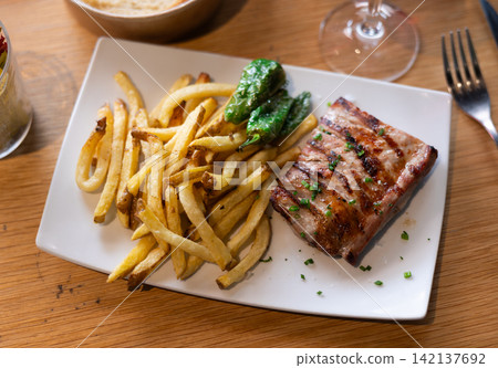 Fried pork with roasted potatoes and grilled peppers Fried pork with roasted potatoes and grilled peppers 142137692