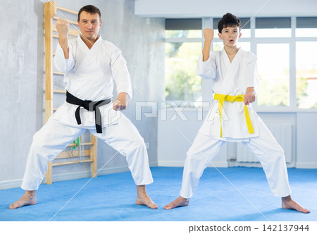 Man and boy teenager train karate technique 142137944