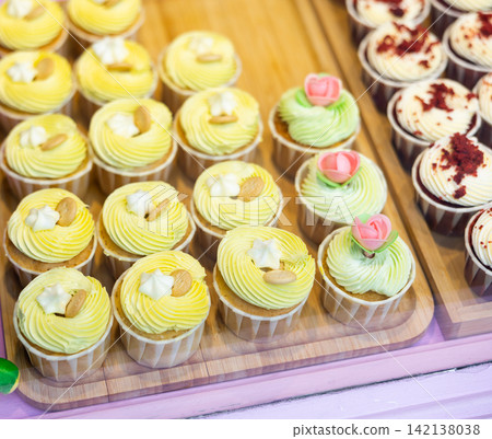 Variety of cupcakes in window of coffee shop or store Variety of cupcakes in window of coffee shop or store 142138038