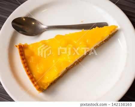 Piece of mango tart on a plate Piece of mango tart on a plate 142138163