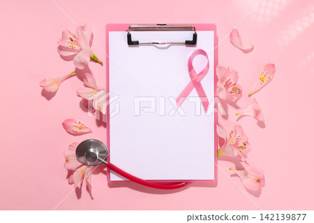 Clip board with blank paper and pink ribbon surrounded by flowers Clip board with blank paper and pink ribbon surrounded by flowers 142139877