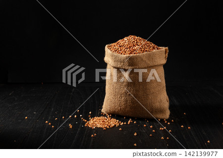 raw Whole Buckwheat Groats Seeds in Burlap Sack raw Whole Buckwheat Groats Seeds in Burlap Sack 142139977
