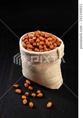 raw shelled peanuts with red skin in canvas sack for snack and culinary recipe raw shelled peanuts with red skin in canvas sack for snack and culinary recipe 142140031