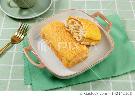 soft Custard Cream Swiss Rolls Served On Green Ceramic Plate soft Custard Cream Swiss Rolls Served On Green Ceramic Plate 142141168