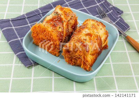 savory Pork Floss Bread Rolls Served On Black Plate With Fork savory Pork Floss Bread Rolls Served On Black Plate With Fork 142141171