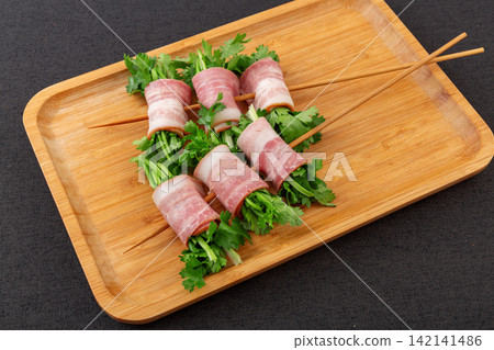 raw Bacon Wrapped Cilantro Skewers on Metal Skewers raw Bacon Wrapped Cilantro Skewers on Metal Skewers 142141486