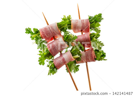 raw Bacon Wrapped Cilantro Skewers on Metal Skewers raw Bacon Wrapped Cilantro Skewers on Metal Skewers 142141487