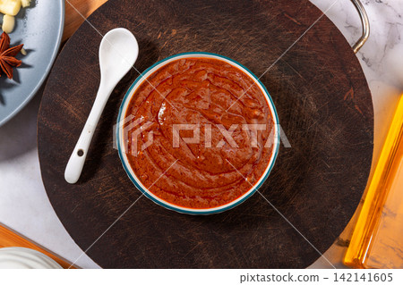 savory Brown Sauce Paste in Blue Ceramic Bowl savory Brown Sauce Paste in Blue Ceramic Bowl 142141605