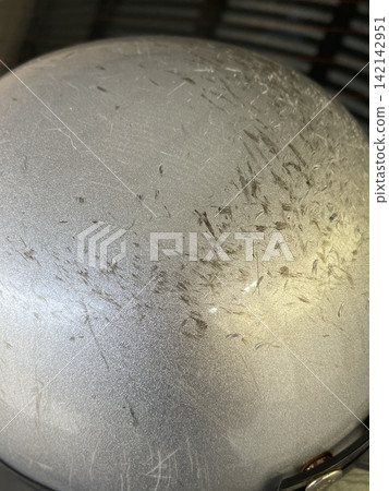 Scratched Silver Helmet Surface Close-Up Scratched Silver Helmet Surface Close-Up 142142951