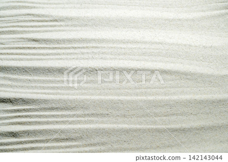 White sand texture with elegant ripple patterns, perfect for zen, relaxation, spa, and minimalist backgrounds. Summer, natural or texture background 142143044
