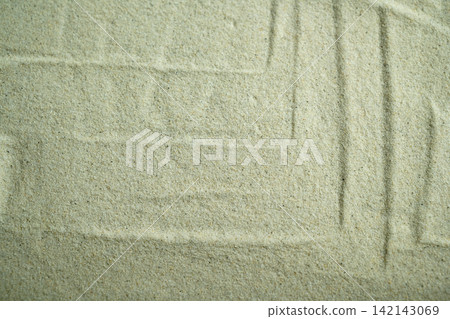 A top-down close-up shot of fine beige sand showing subtle raked geometric patterns and lines, creating a calm, minimalist textured background. Summer, natural or texture background A top-down close-up shot of fine beige sand showing subtle raked geometric patterns and lines, creating a calm, minimalist textured background. Summer, natural or texture background 142143069