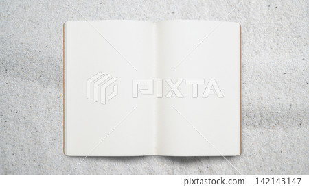Overhead view of an open blank notebook on a textured concrete or sand background, providing clean copy space Overhead view of an open blank notebook on a textured concrete or sand background, providing clean copy space 142143147