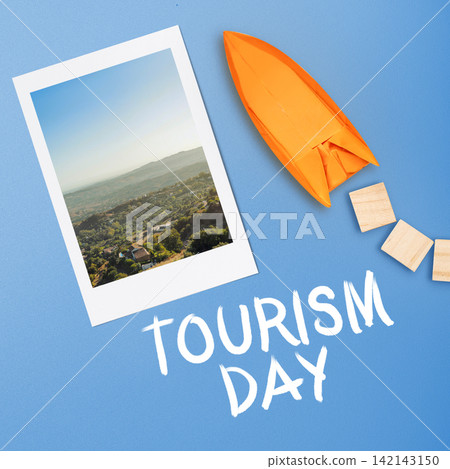 Flat lay composition celebrating World Tourism Day with a scenic landscape photo, an orange origami rocket, and hand-written text on a blue background. Tourism Day Concept Flat lay composition celebrating World Tourism Day with a scenic landscape photo, an orange origami rocket, and hand-written text on a blue background. Tourism Day Concept 142143150