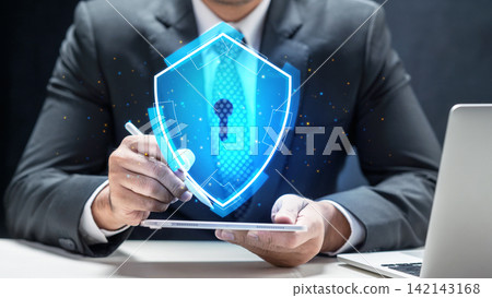 Businessman holding tablet with glowing blue holographic shield icon, representing cybersecurity and data protection. Concept of Digital Protection Businessman holding tablet with glowing blue holographic shield icon, representing cybersecurity and data protection. Concept of Digital Protection 142143168
