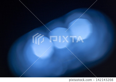 Abstract out of focus blue bokeh lights against a black background. Abstract blue background Abstract out of focus blue bokeh lights against a black background. Abstract blue background 142143208