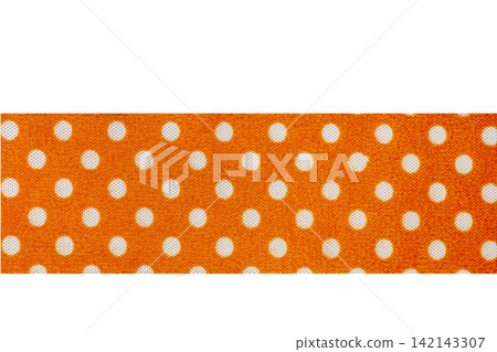 A horizontal strip of orange fabric ribbon with a classic white polka dot pattern, isolated on a white background 142143307
