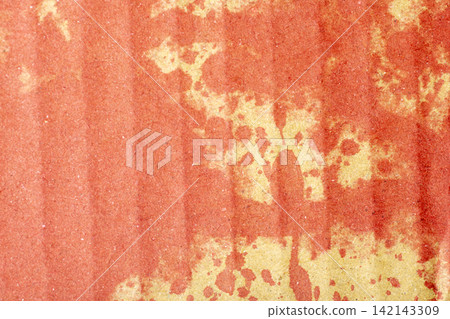 Abstract grunge background featuring red ink splatters and stains on textured corrugated cardboard paper. Halloween concept Abstract grunge background featuring red ink splatters and stains on textured corrugated cardboard paper. Halloween concept 142143309