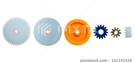 Row of various plastic and metal toy gears and pulleys of different colors isolated on a white background Row of various plastic and metal toy gears and pulleys of different colors isolated on a white background 142143326