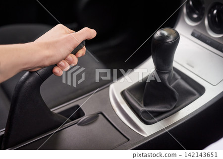 Car, hand brake and person with interior to drive motor vehicle for petrol, speed and clutch control for journey. Auto, travel and zoom of luxury automobile for transmission, neutral or parking gear 142143651
