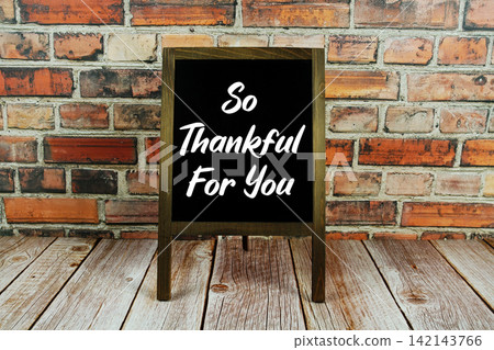 So Thankful For You text written on easel on wooden backgrond So Thankful For You text written on easel on wooden backgrond 142143766