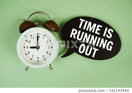 Time is Running Out text on speech bubble with alarm clock on green background Time is Running Out text on speech bubble with alarm clock on green background 142143840