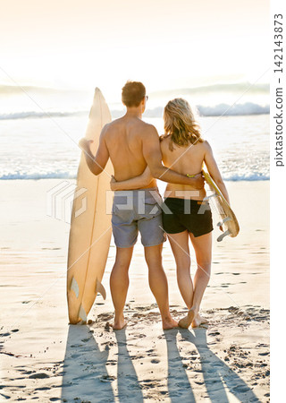 Surfboard, hug or couple at sea for adventure, anniversary or sports exercise in Miami, Florida. Healthy surfers, back view or people ready for surfing on holiday vacation at beach or ocean in summer Surfboard, hug or couple at sea for adventure, anniversary or sports exercise in Miami, Florida. Healthy surfers, back view or people ready for surfing on holiday vacation at beach or ocean in summer 142143873