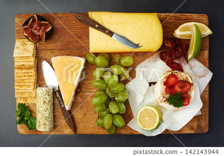 Food, grapes or cheese board in restaurant choice for catering service, dish or snack selection for eating. Cafeteria, buffet and top view of table for lunch, supper and dinner event on background Food, grapes or cheese board in restaurant choice for catering service, dish or snack selection for eating. Cafeteria, buffet and top view of table for lunch, supper and dinner event on background 142143944