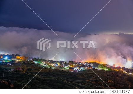 Alishan night view with rolling clouds and tea plantations in Chiayi, Taiwan Alishan night view with rolling clouds and tea plantations in Chiayi, Taiwan 142143977