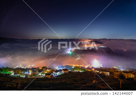 Starlit night sky over sea of clouds and mountain village in Chiayi, Taiwan Starlit night sky over sea of clouds and mountain village in Chiayi, Taiwan 142144007
