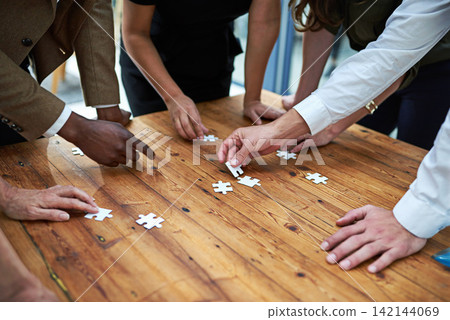 Puzzle, group and business hands with problem solving, collaboration and integration for project solution. Creative staff or group with game for team building, planning or brainstorming in meeting 142144069