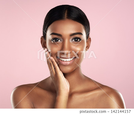 Portrait, beauty and Indian woman with cosmetics, skincare or dermatology on pink studio background. Face, person or model with healthy skin, makeup or shine with vibrant glow or wellness with luxury Portrait, beauty and Indian woman with cosmetics, skincare or dermatology on pink studio background. Face, person or model with healthy skin, makeup or shine with vibrant glow or wellness with luxury 142144157