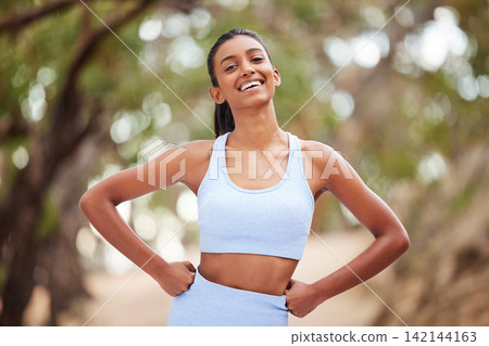 Woman, portrait and happy athlete in nature, runner and body wellness or health in forest for cardio workout. Sports, exercise and outdoor for vitality, sportswear and confident for training goals 142144163